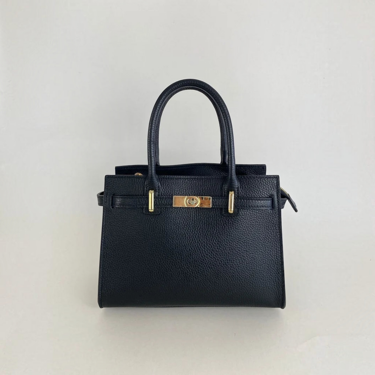 Plum Bottom LE FEME CHATEAU medium black Italian leather handbag with gold hardware and a top zipper closure.