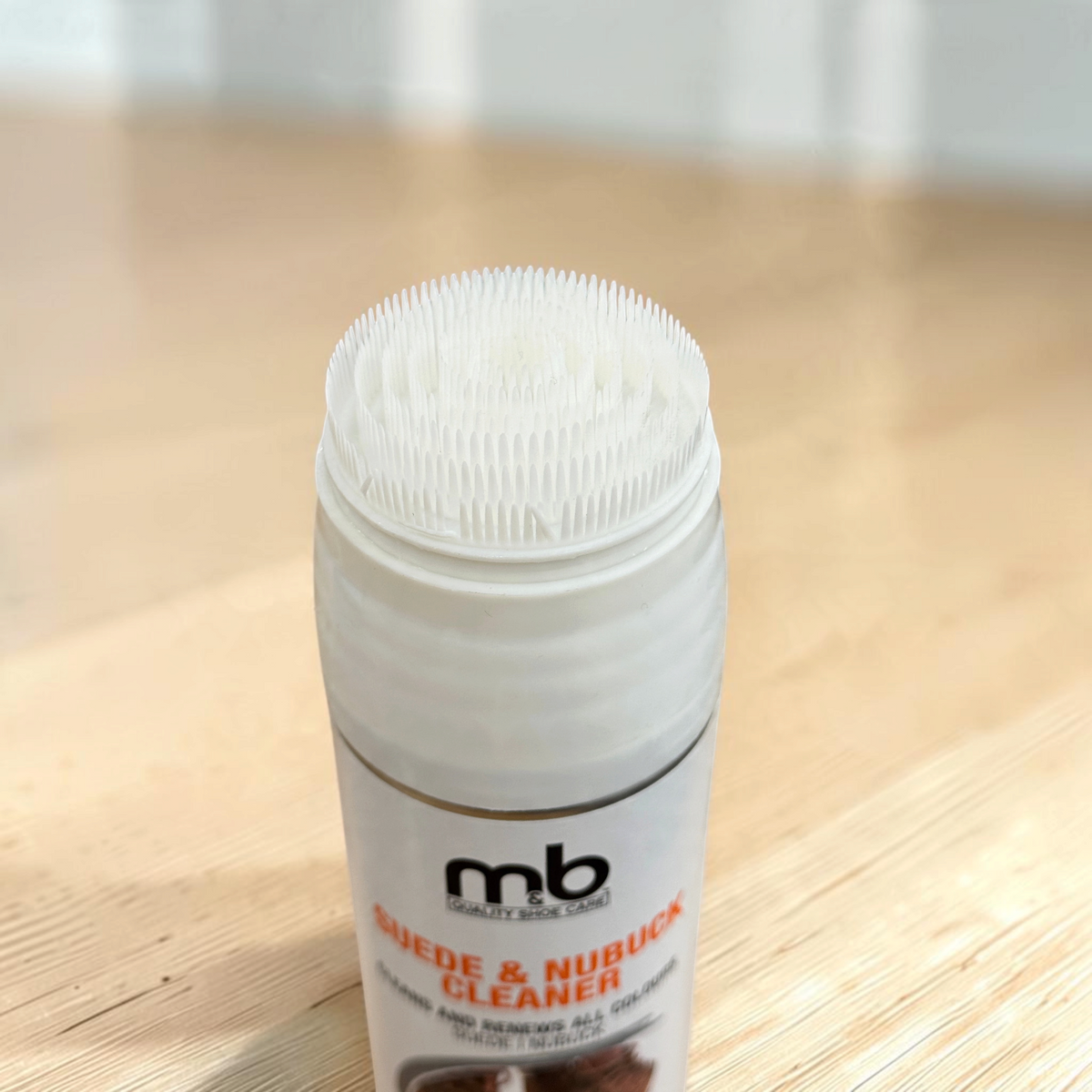 Plum Bottom MB suede and nubuck cleaner aerosol can featuring a built-in white plastic brush cap for shoe care