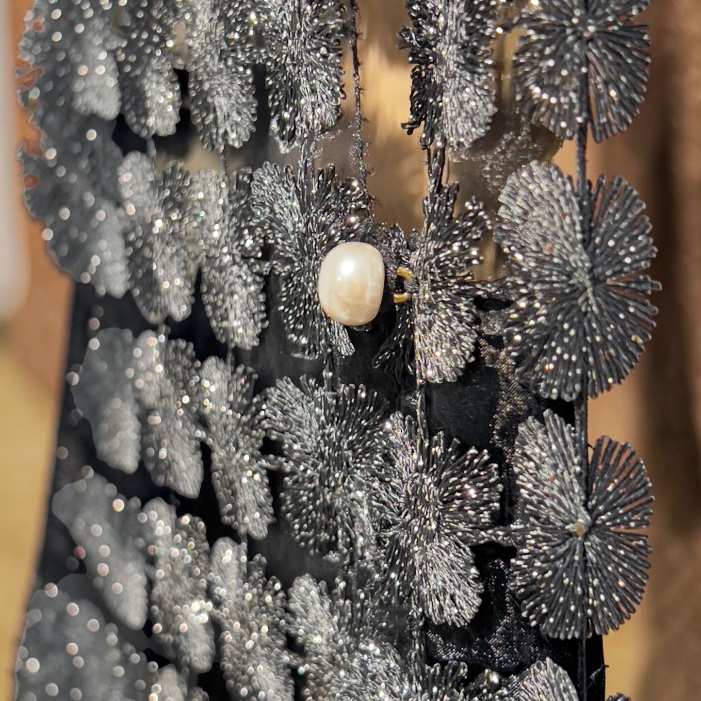 Plum Bottom ELLYNDALE black organza sleeveless vest featuring intricate lace floral patterns and a pearl button detail