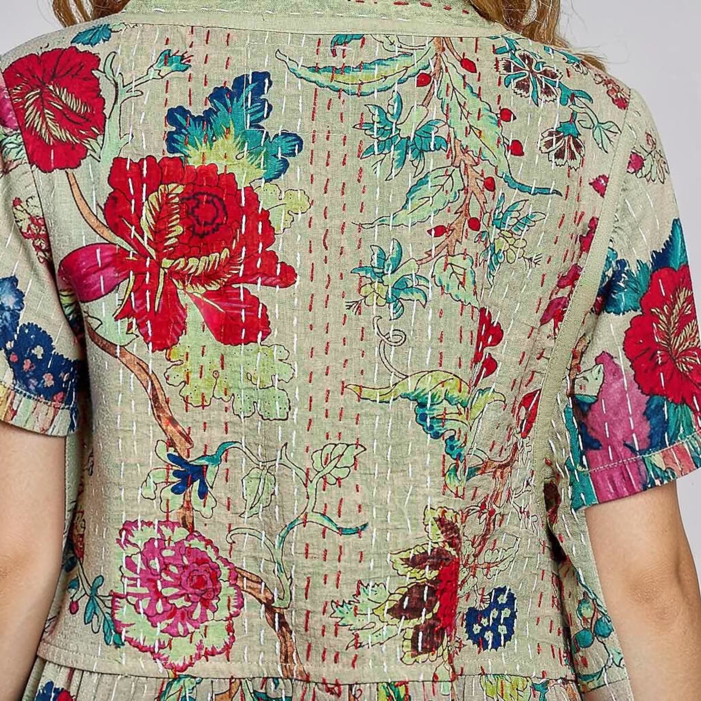Plum Bottom Pol Clothing quilted kimono-style top in powder olive with vibrant floral print and contrast hand-stitching