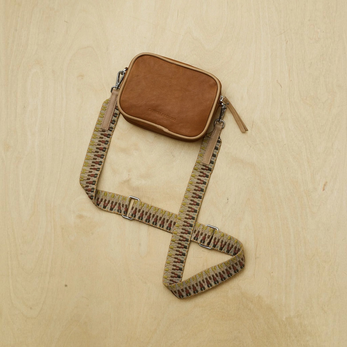 Plum Bottom DANIELLA LEHAVI Lima Day Bag in brown lambskin leather with a patterned, detachable fabric strap.