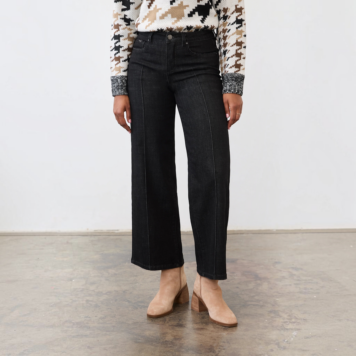 Plum Bottom FDJ Olivia black wide leg jeans featuring a front pintuck detail, worn with a patterned sweater.