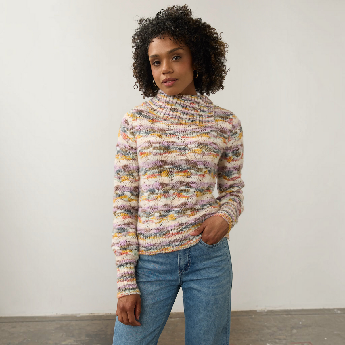 Plum Bottom FDJ envelope collar sweater in a multi-colored space dye knit worn by a model with blue jeans.