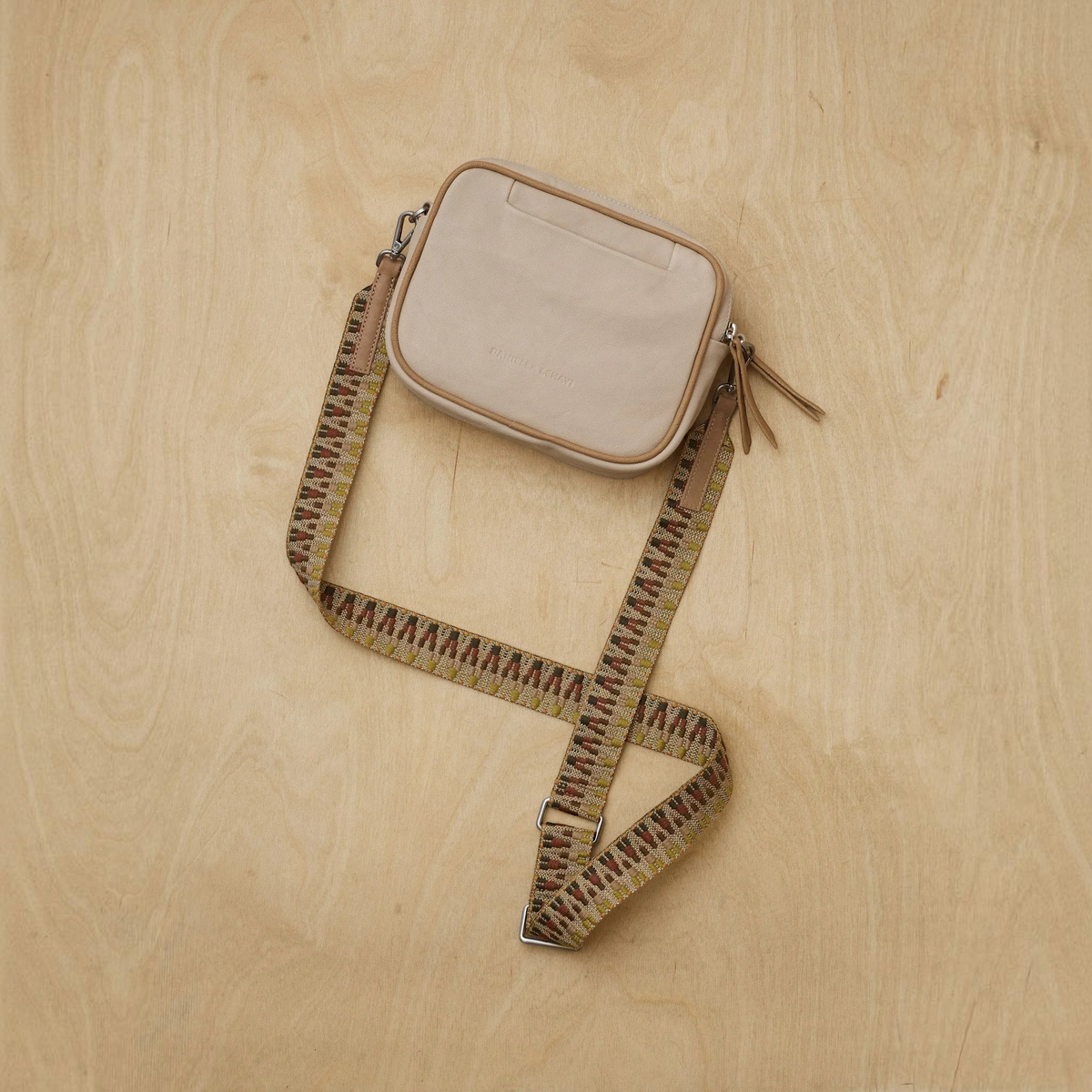 Plum Bottom DANIELLA LEHAVI Lima Day Bag in beige lambskin leather with a patterned, detachable fabric strap.