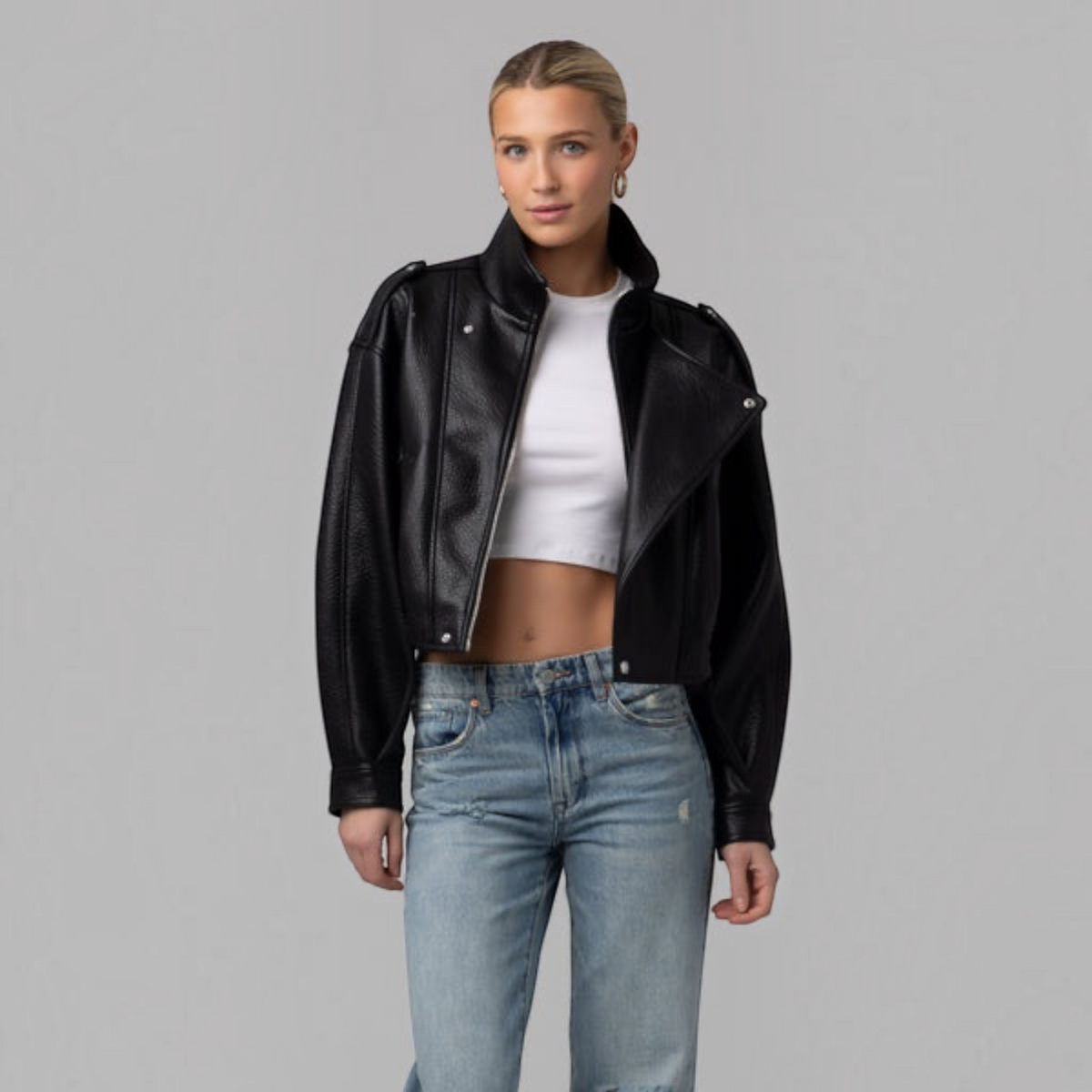 Plum Bottom BLANK NYC black vegan leather moto jacket with asymmetrical zip and notched collar on a female model