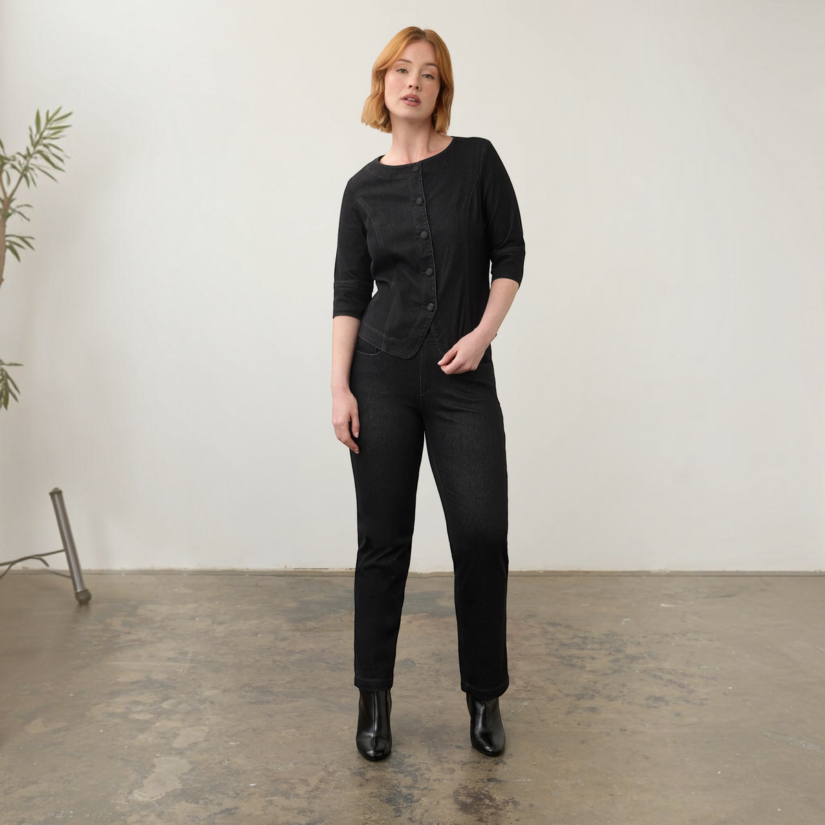 Model wearing Plum Bottom FDJ black pull-on straight leg jeans and a matching button-up denim jacket