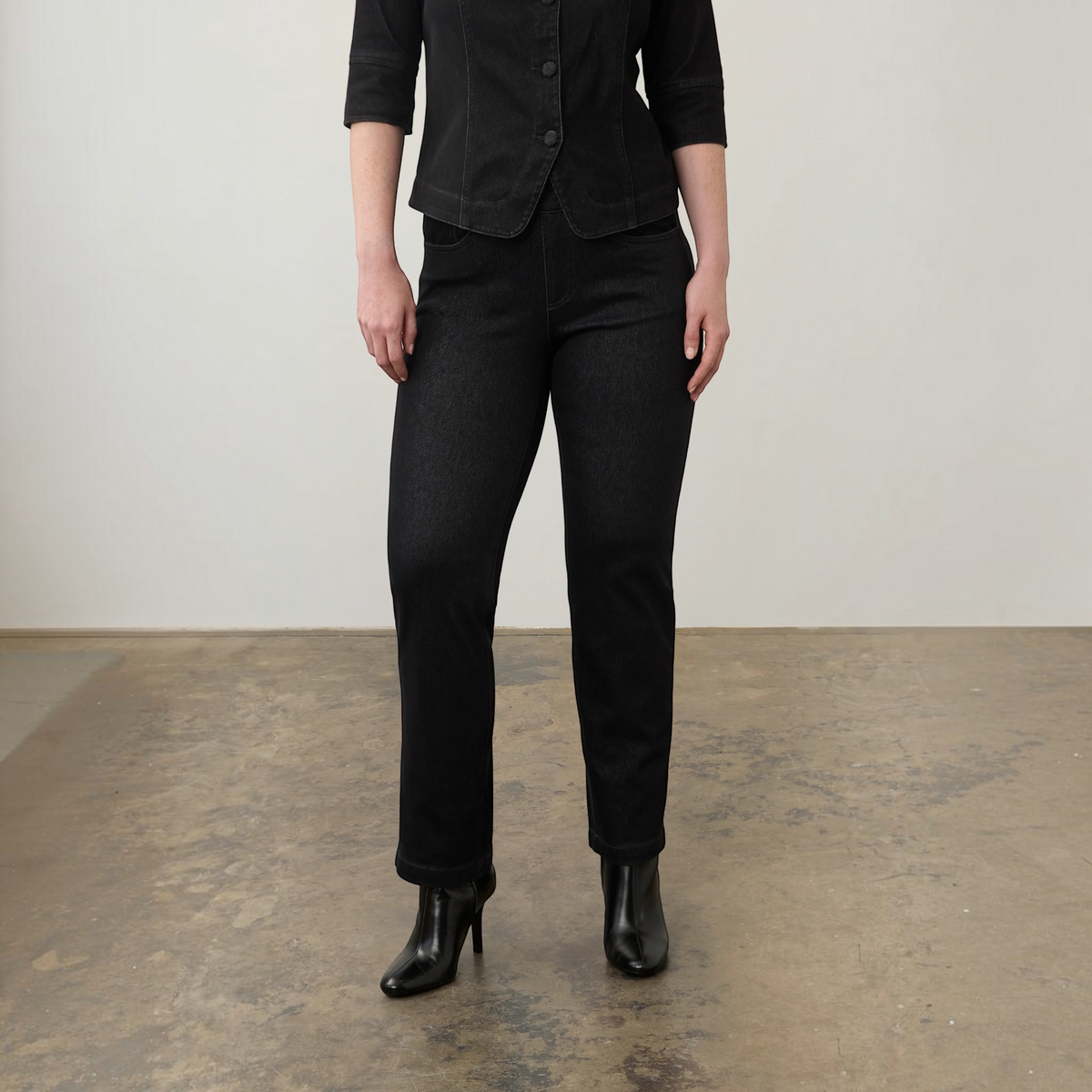 Plum Bottom FDJ pull-on straight leg jeans in black denim paired with a matching jacket and black heeled boots.