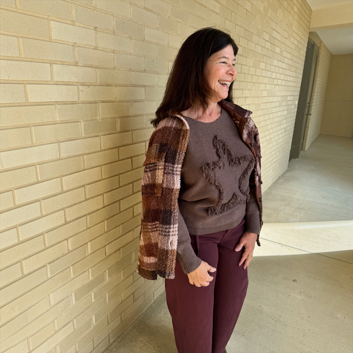 Plum Bottom BEACH LUNCH LOUNGE Tory plaid flannel jacket worn over a brown star-detail sweater and maroon trousers