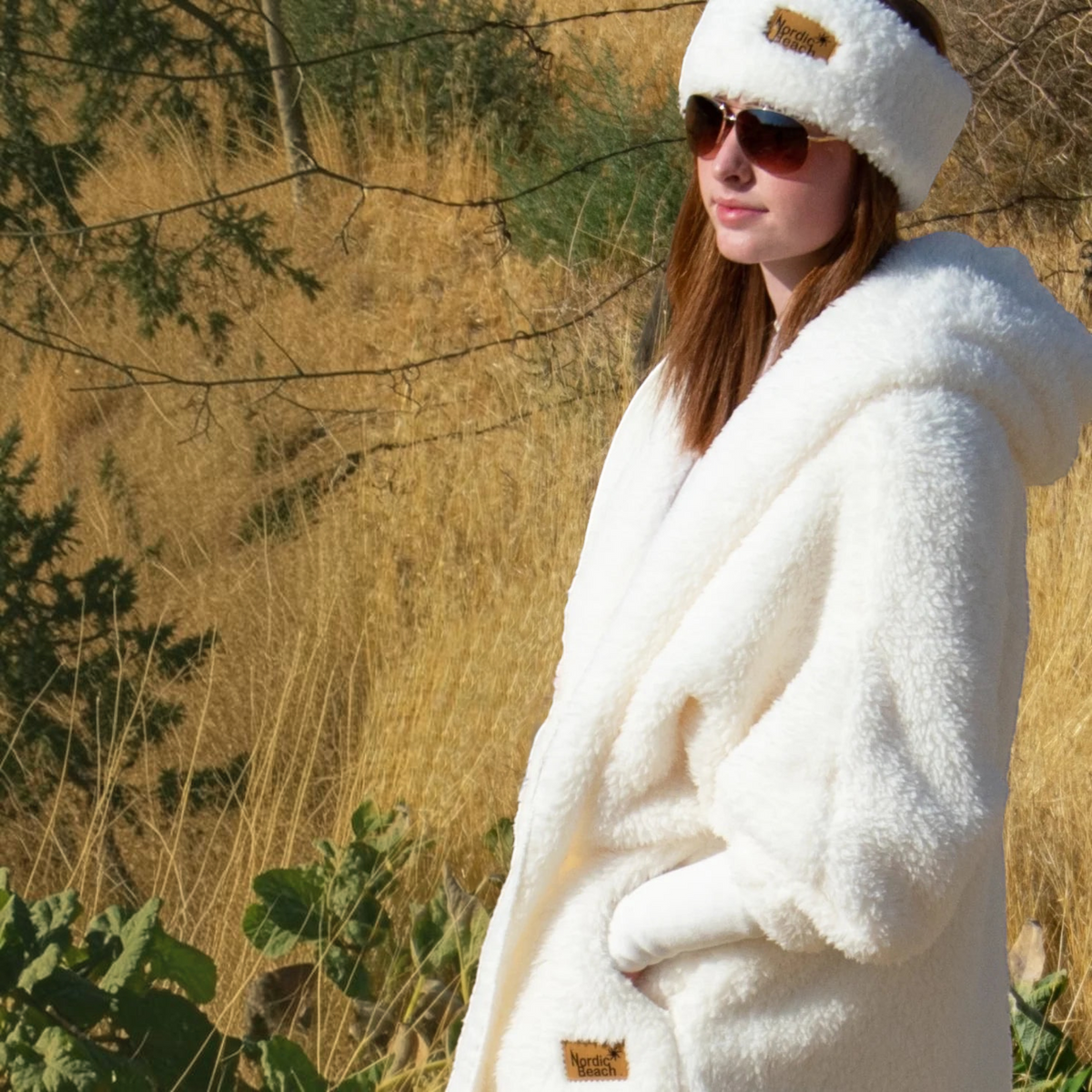 Plum Bottom NORDIC BEACH white faux fur long body wrap with matching headband worn by a woman in a field