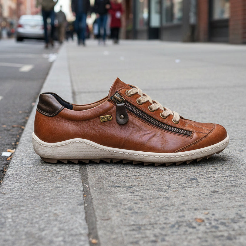 Brown leather shoe with a zipper on a white background