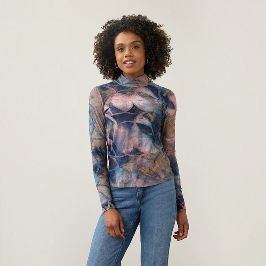 Plum Bottom FDJ long sleeve mock neck top in a blue and pink abstract print knit worn with blue jeans