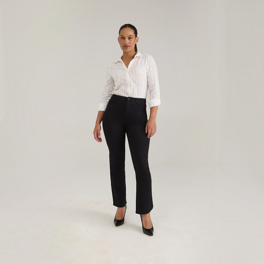 Model wearing Plum Bottom FDJ Peggy black bootleg jeans paired with a white button-down shirt and black heels.