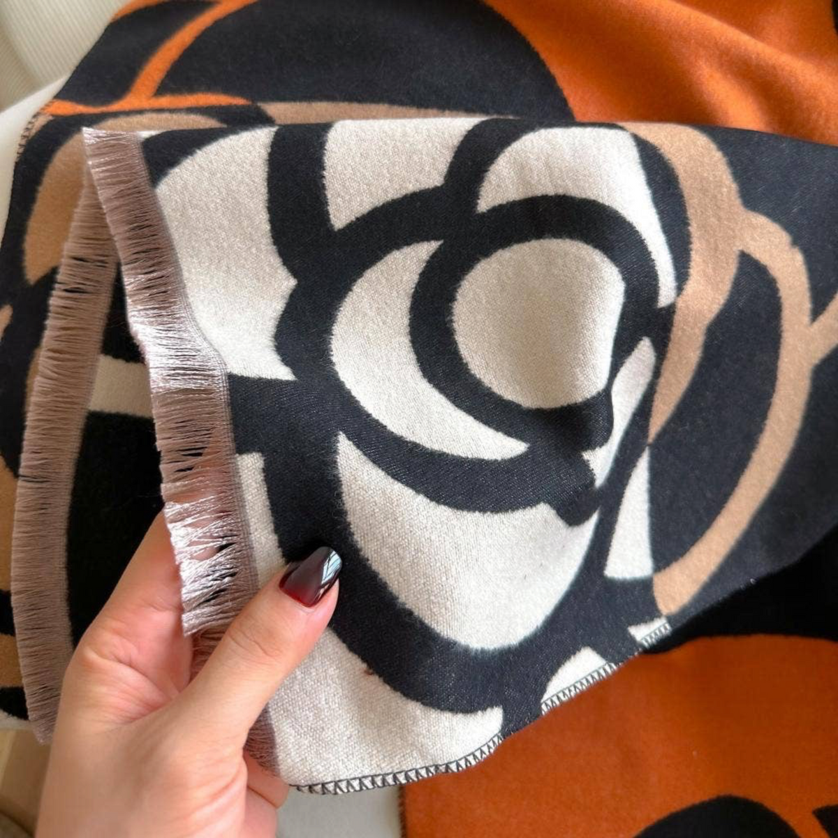 [Winding River - Orange / Black Geo Rose Reversible Wrap], [Scarf], [Winding River], [Plum Bottom].