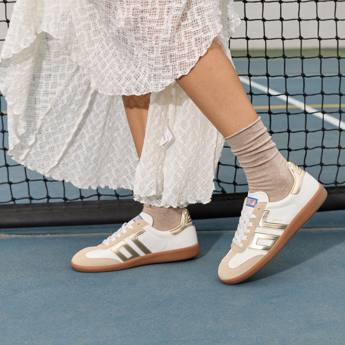 White sneaker with gold numbers