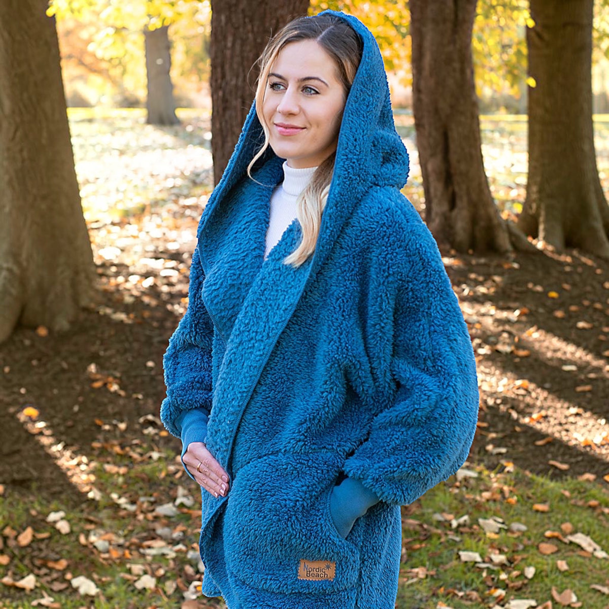 Plum Bottom NORDIC BEACH blue hooded body wrap in fluffy cotton candy fabric worn by a woman in an autumn park