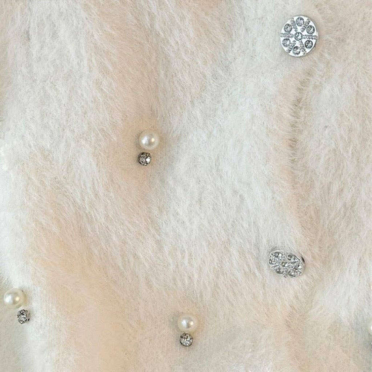 Plum Bottom fluffy bolero featuring scattered white pearls and sparkling diamond-like embellishments on soft fabric.