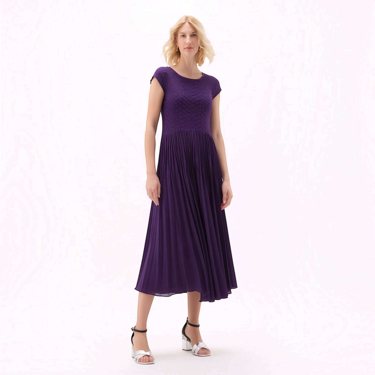 Plum Bottom violet pleated midi dress with cupsleeves worn by a blonde model against a white background