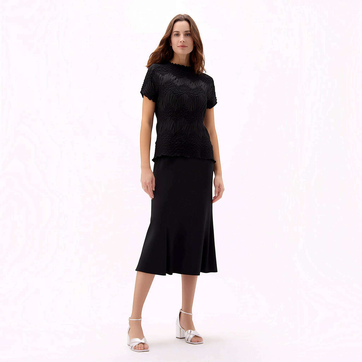 Plum Bottom Ellyndale black short-sleeve top with crochet wave pleating, worn with a matching black midi skirt.