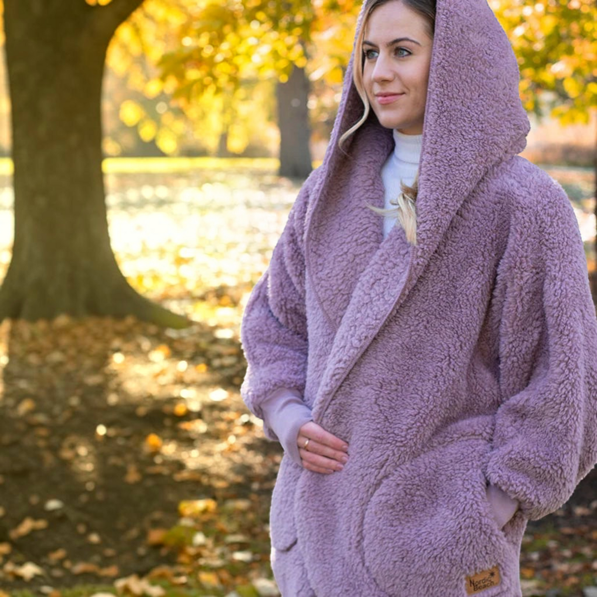 Plum Bottom NORDIC BEACH mauve hooded body wrap in fluffy micro poly fabric worn outdoors in autumn