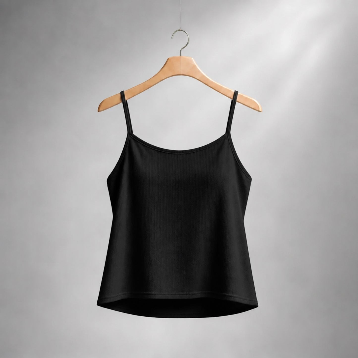 Plum Bottom Ellyndale black camisole top with spaghetti straps on a wooden hanger