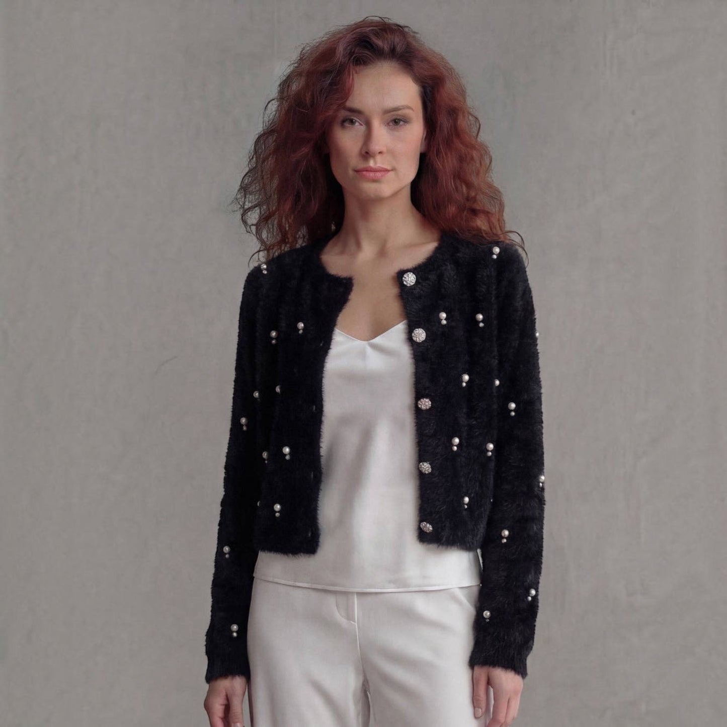 Plum Bottom black fluffy bolero featuring scattered diamond and pearl embellishments worn by a red-haired model.