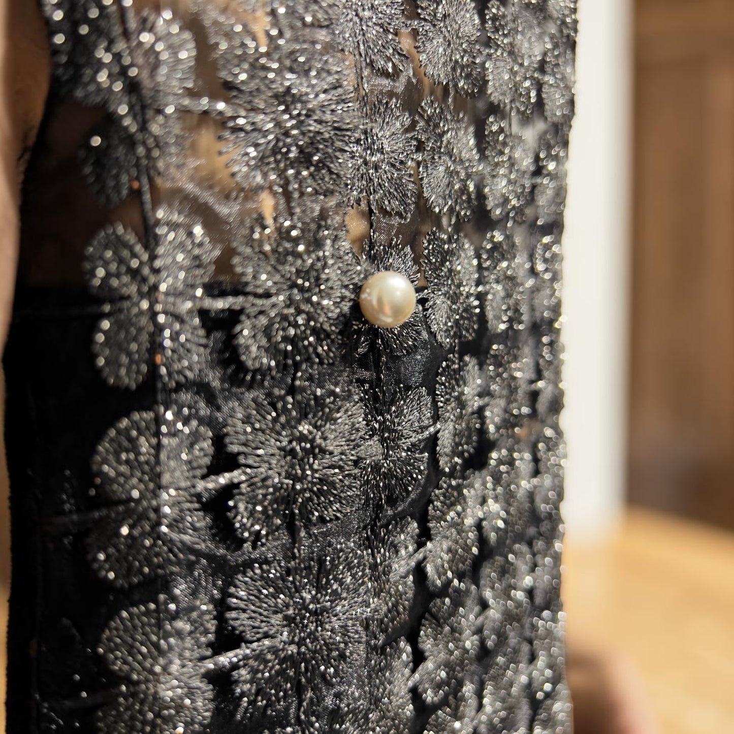 Plum Bottom ELLYNDALE black sleeveless organza lace vest featuring intricate floral embroidery and a pearl button