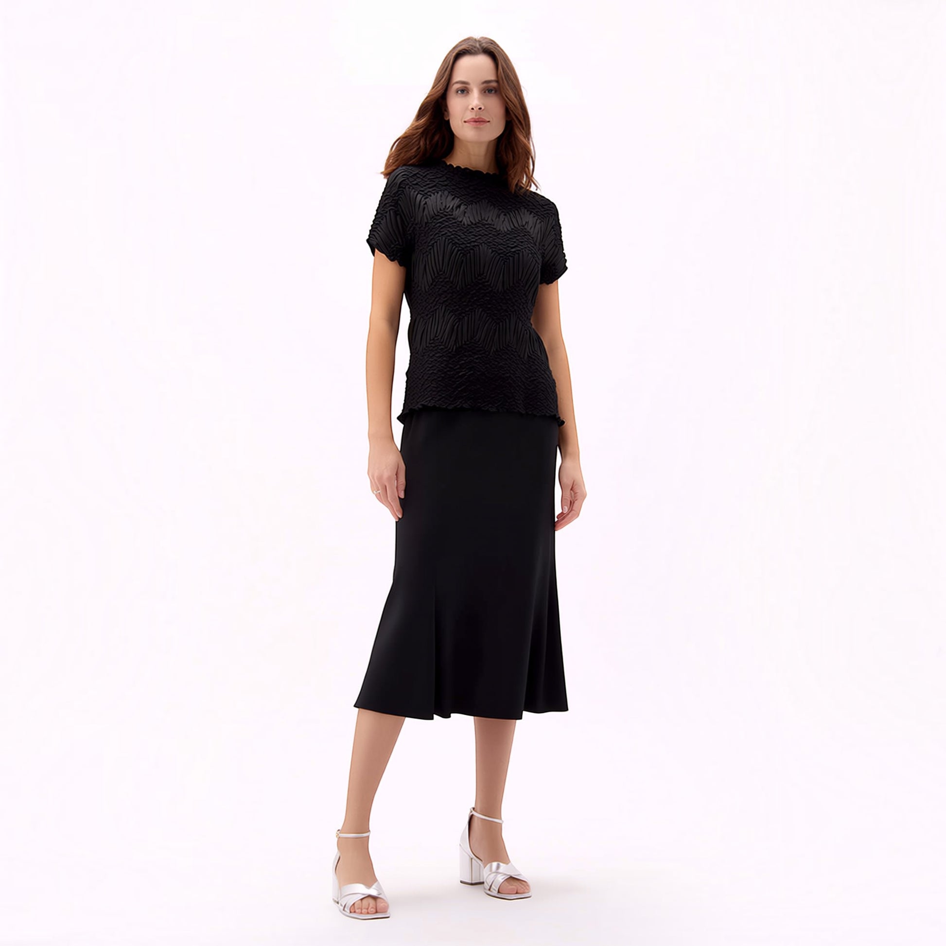 Plum Bottom Ellyndale black short-sleeve top with crochet wave pleating, worn with a matching black midi skirt.