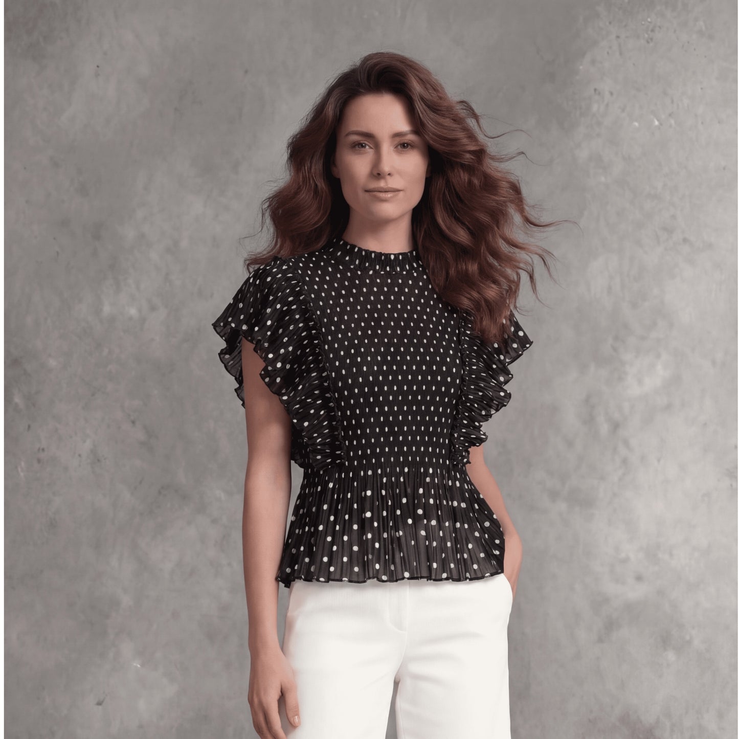 Plum Bottom Ellyndale black polka dot top with pleated ruffle sleeves worn by a model with white culottes