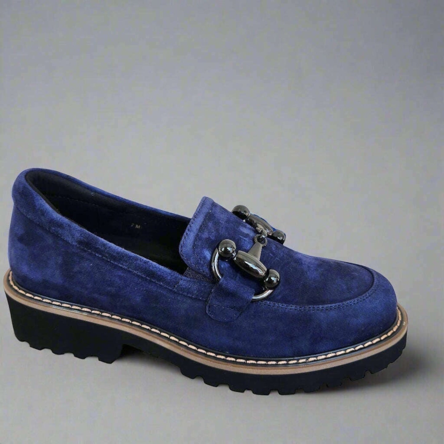 Plum Bottom blue suede loafer with a black metal bit, lug sole, and contrasting tan welt stitching.