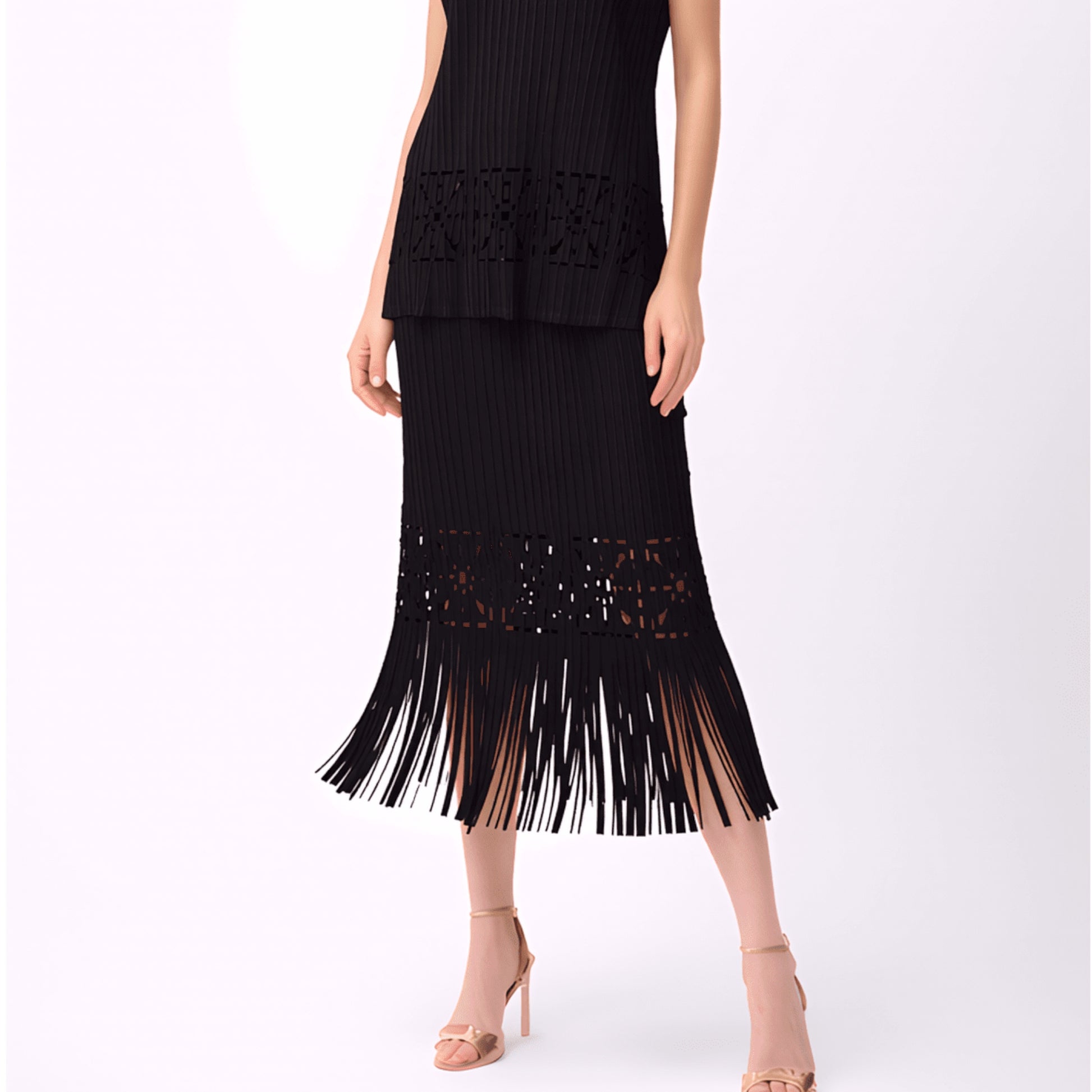 Model wearing Plum Bottom ELLYNDALE black pleated midi skirt with cutout details and a soft fringe hem.