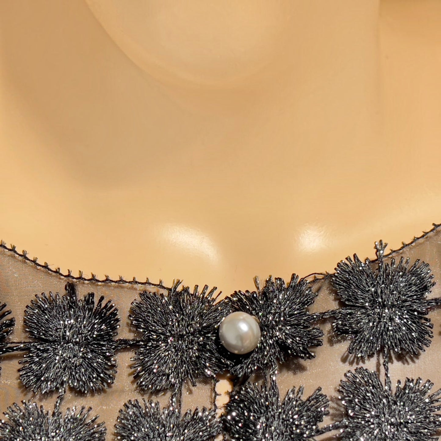 Plum Bottom ELLYNDALE black organza sleeveless vest featuring intricate lace floral details and a pearl button closure.