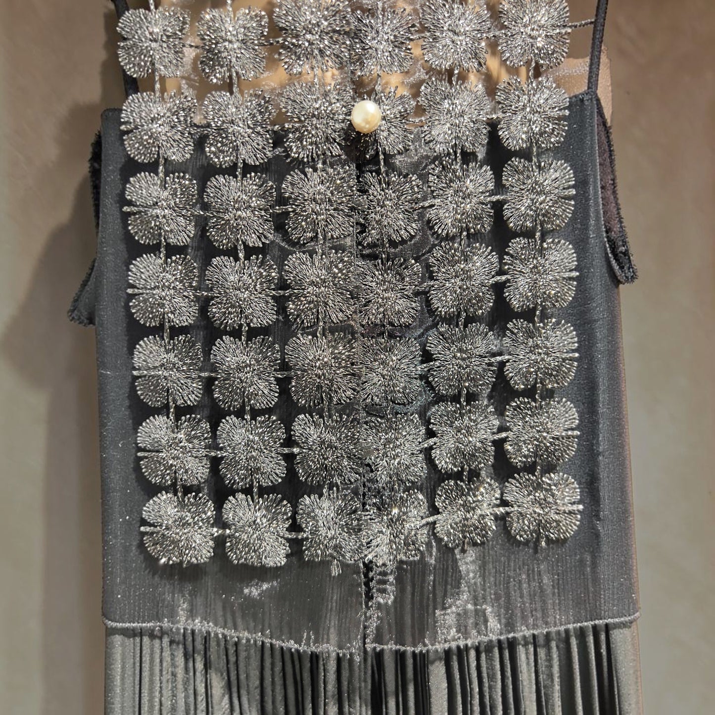 Plum Bottom ELLYNDALE black sleeveless organza vest featuring intricate metallic lace floral patterns and pearl buttons
