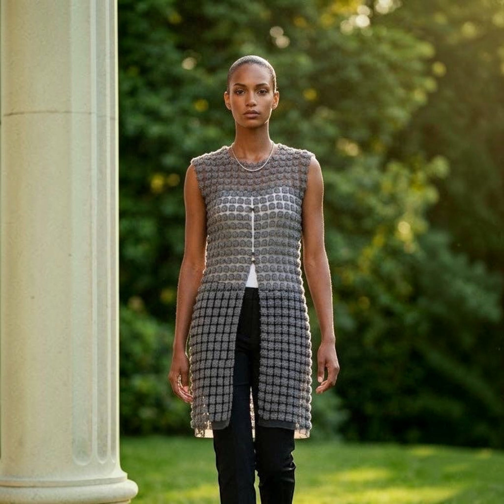 Plum Bottom ELLYNDALE black lace organza sleeveless long vest with pearl button front worn by a model outdoors.