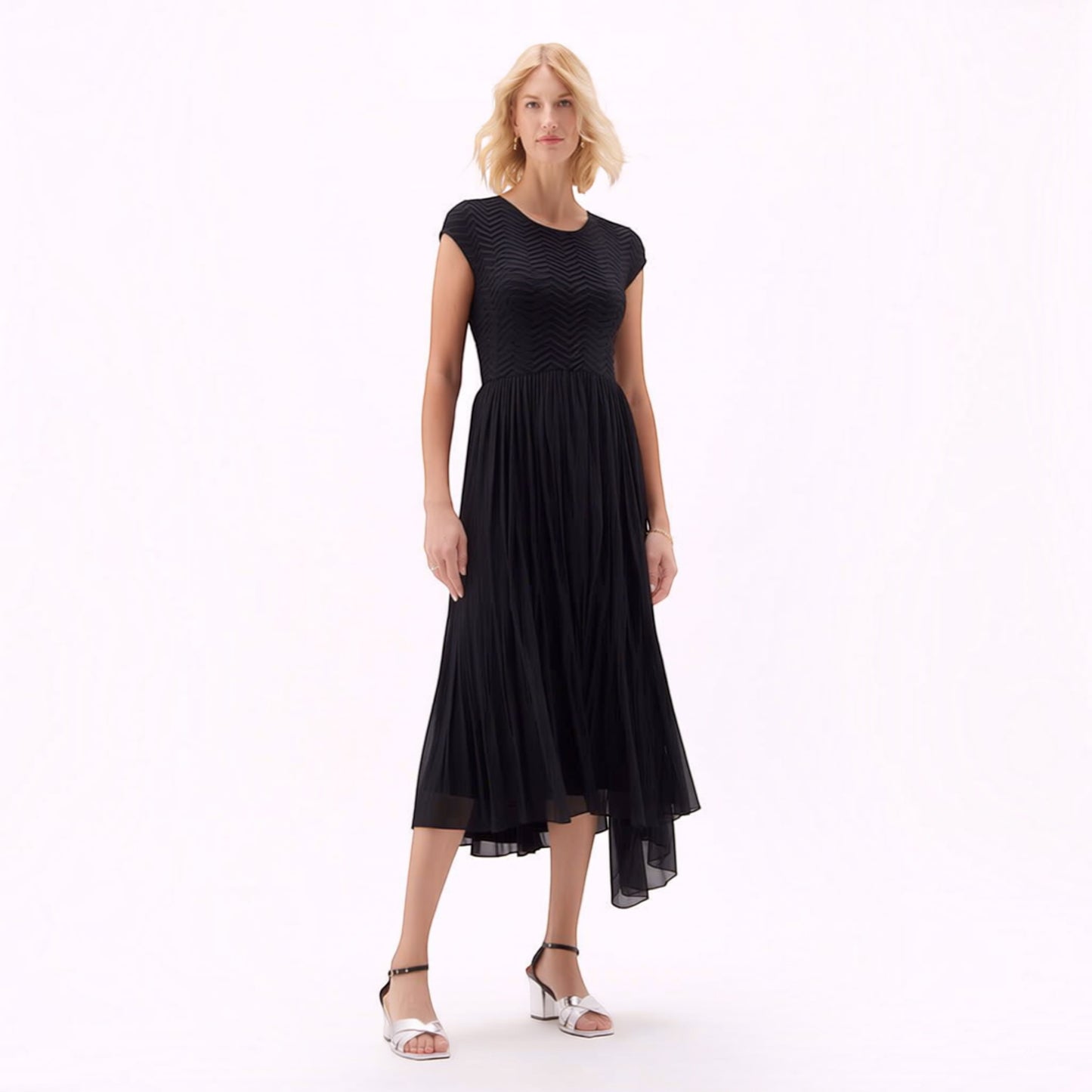 Plum Bottom Ellyndale black pleated dress with cupsleeves and a high-low hem worn by a blonde model.