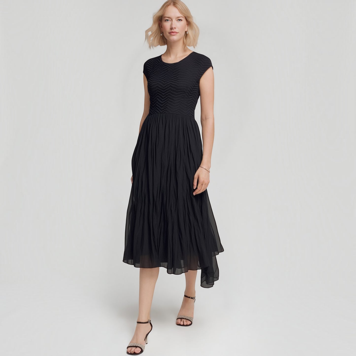 Plum Bottom Ellyndale black pleated midi dress with cupsleeves worn by a blonde model on a white background
