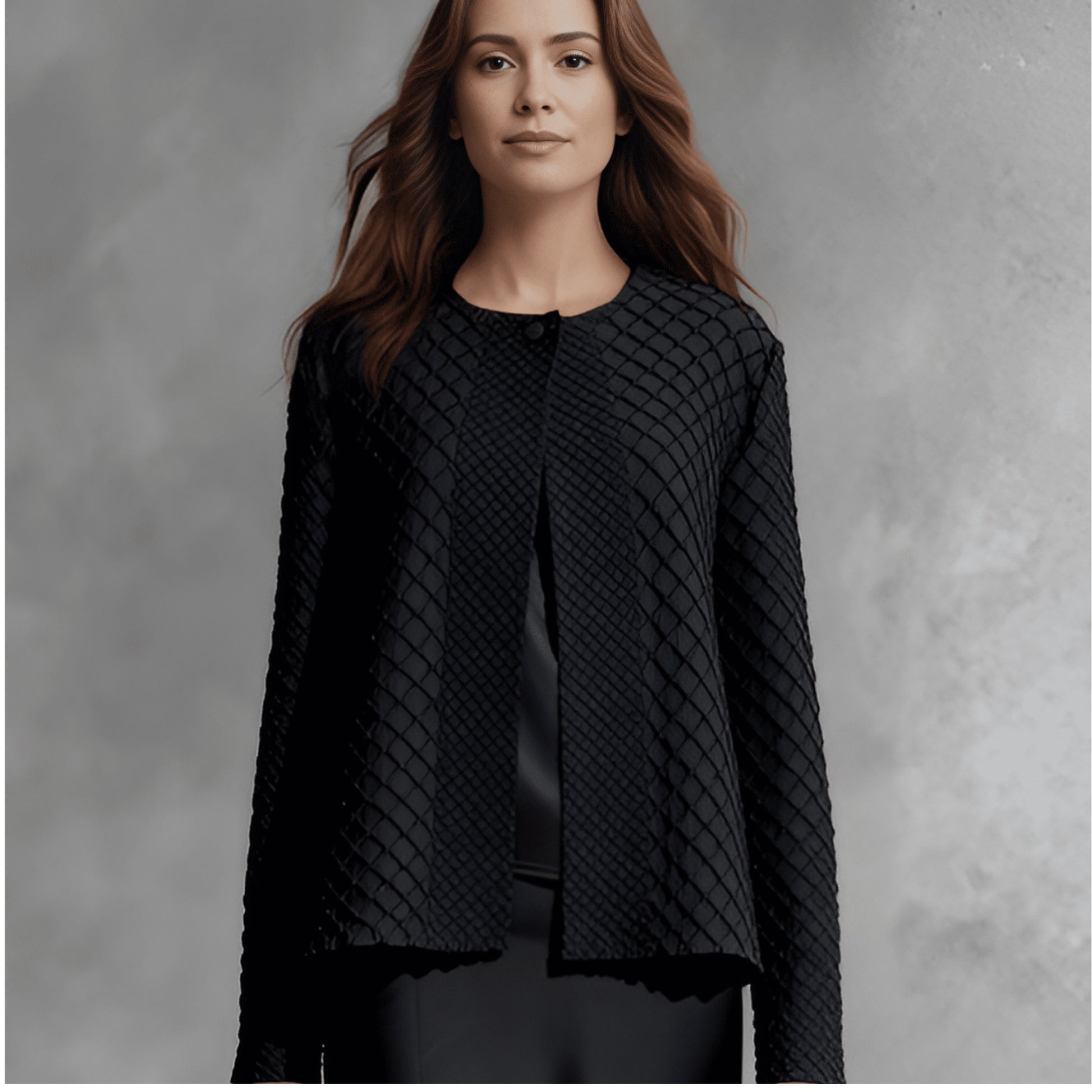 Plum Bottom ELLYNDALE black waffle weave pleated jacket with a round neckline and structured open front design.