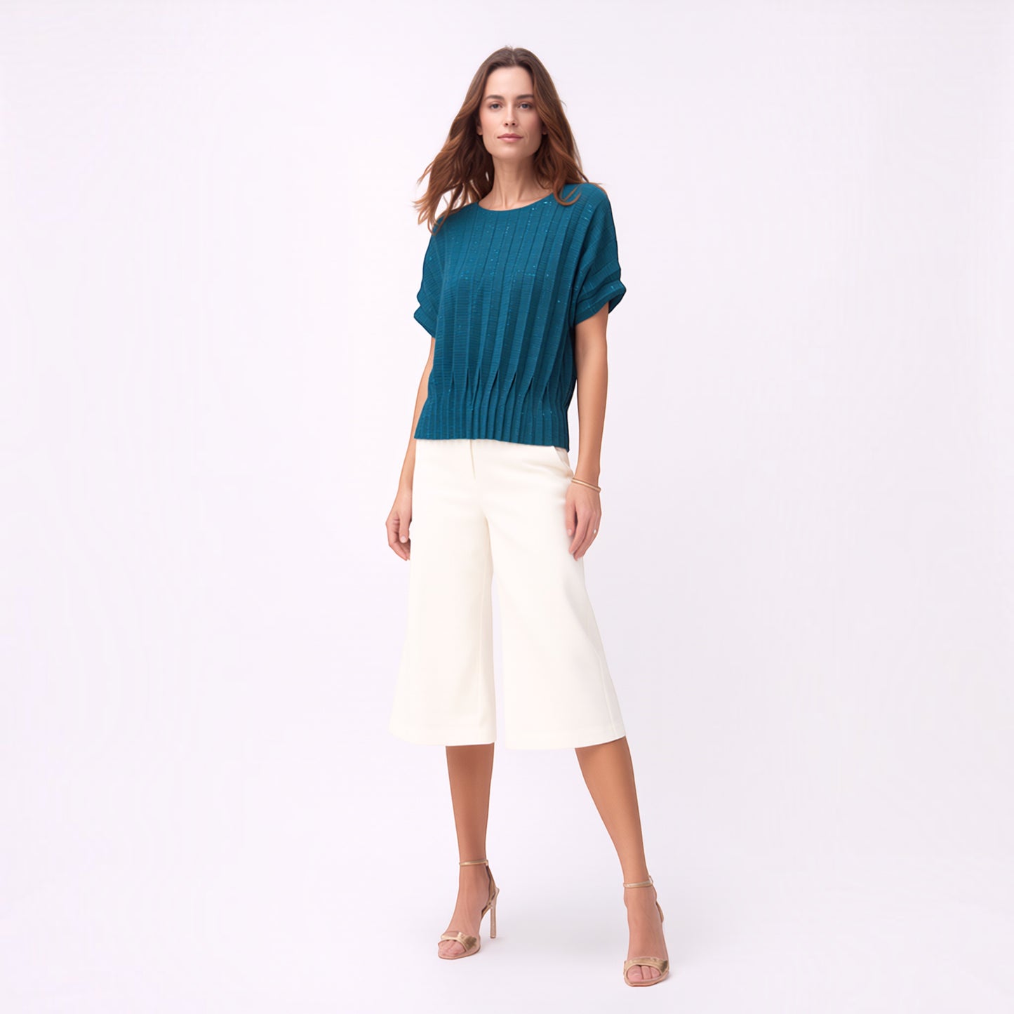 Model wearing a Plum Bottom ELLYNDALE blue pleated short-sleeve top with a dual fold design and white culottes.