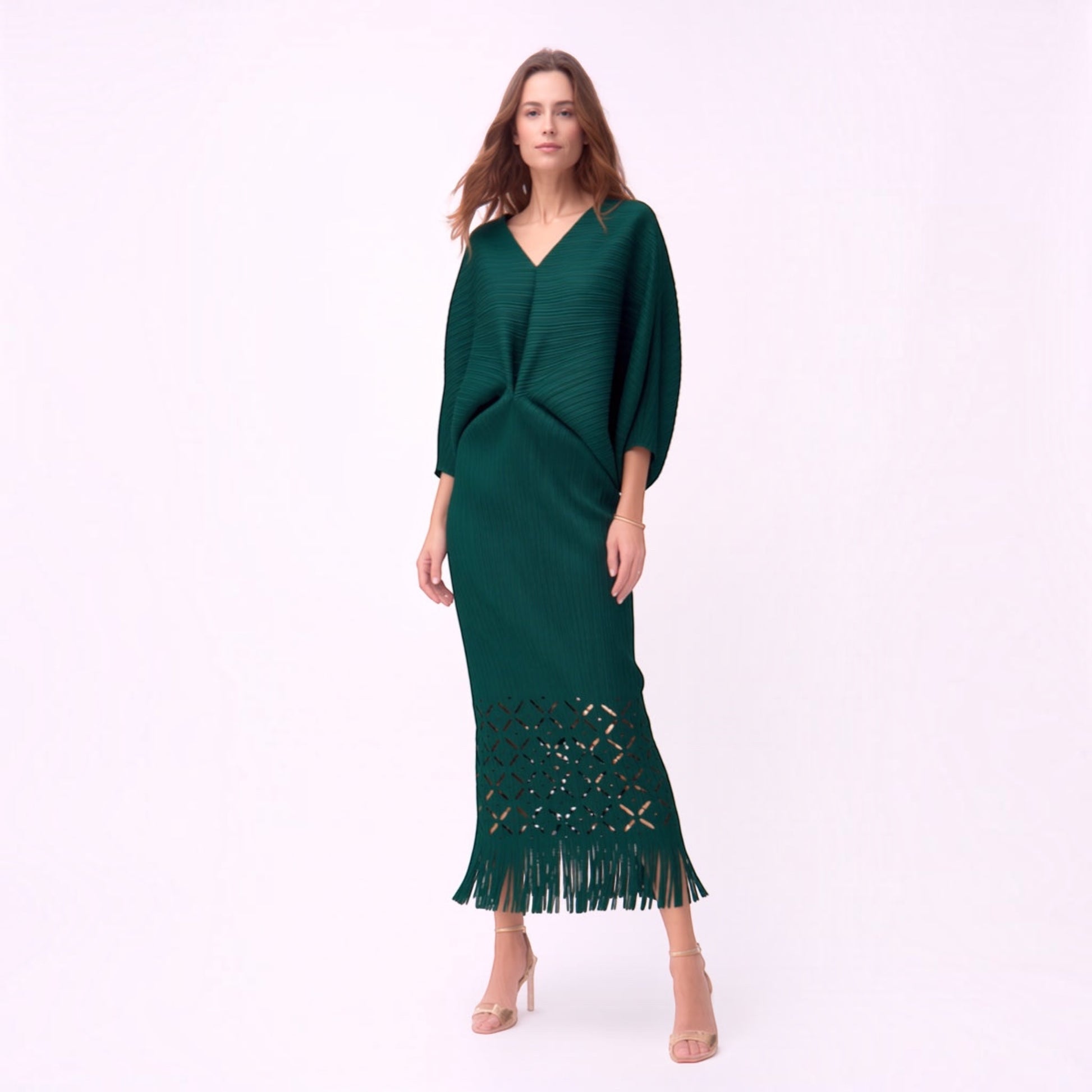 Plum Bottom ELLYNDALE dark green pleated midi dress with waist cutout, laser-cut hem, and fringe detail on model