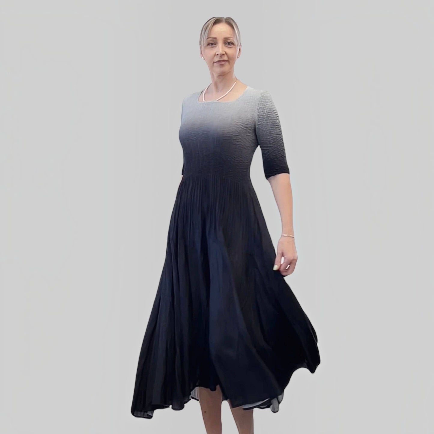 Plum Bottom ELLYNDALE pleated ombre dress in black and grey with 3/4 sleeves worn by a model