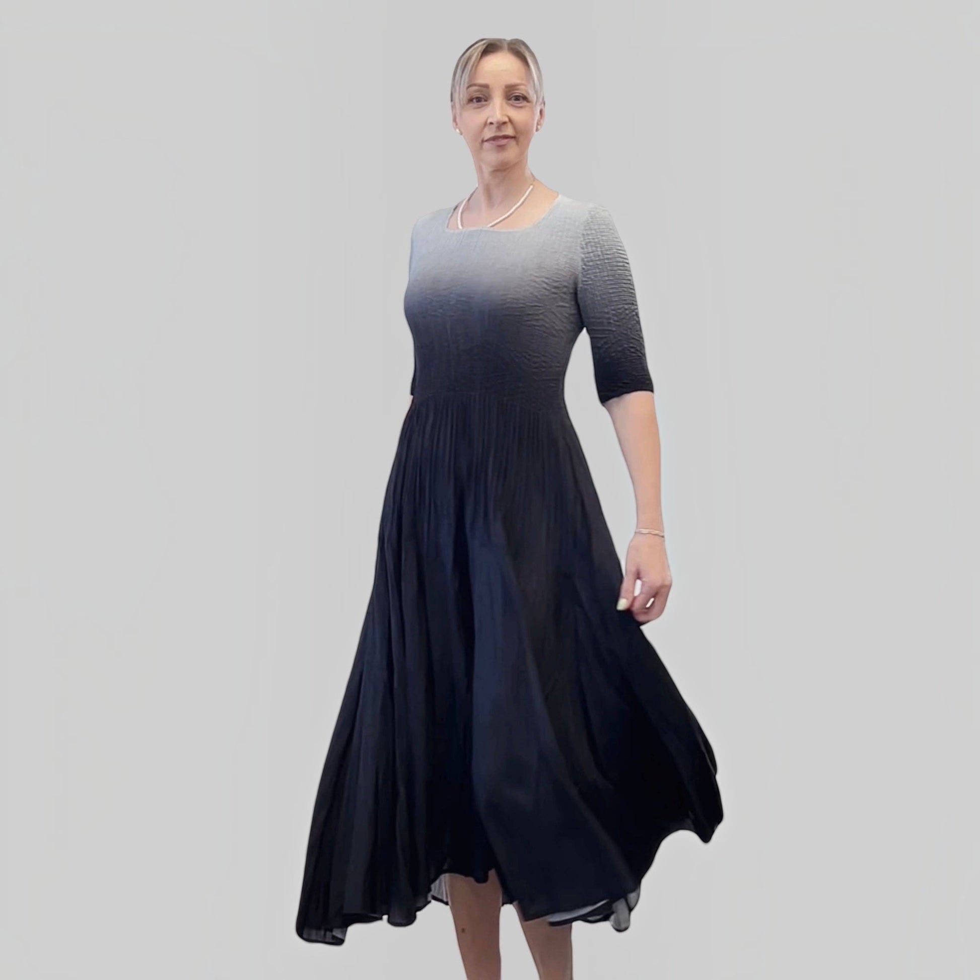 Plum Bottom ELLYNDALE pleated ombre dress in black and grey with 3/4 sleeves worn by a model