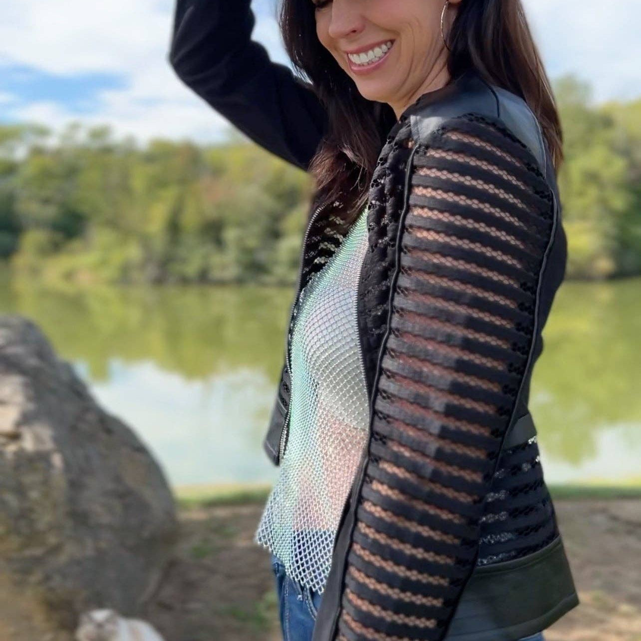 Plum Bottom ELLYNDALE Shadow Jacket featuring black faux leather and mesh stripe panels in a stylish outdoor setting.