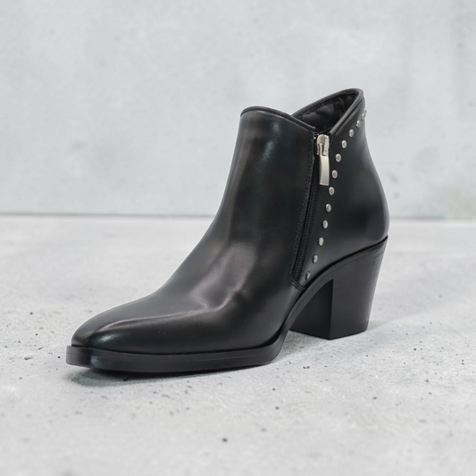 Plum Bottom Eric Michael Muriel black leather ankle boot with side zipper and silver stud accents on a block heel