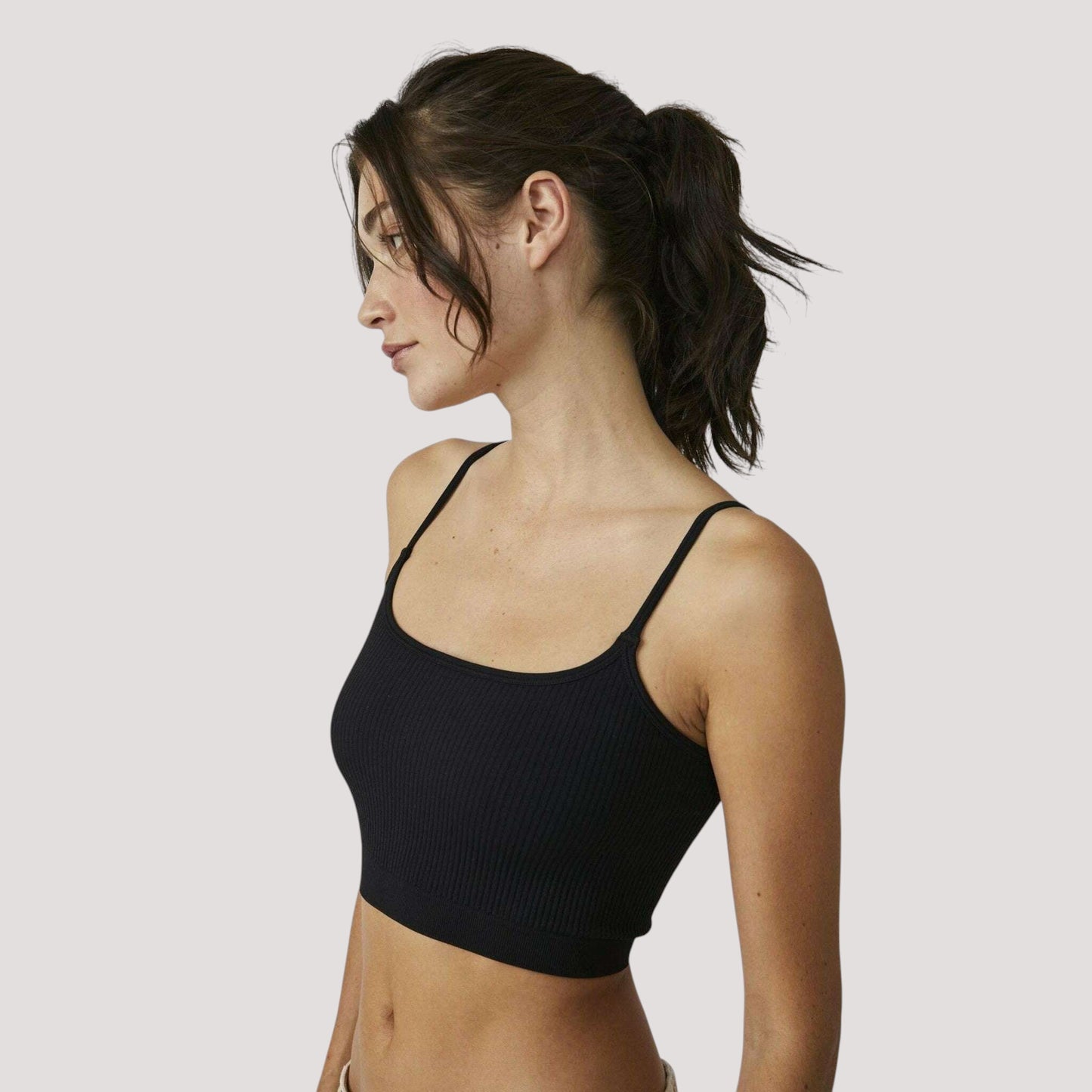 Plum Bottom Free People recycled ribbed brami in black worn by a model in a side profile view