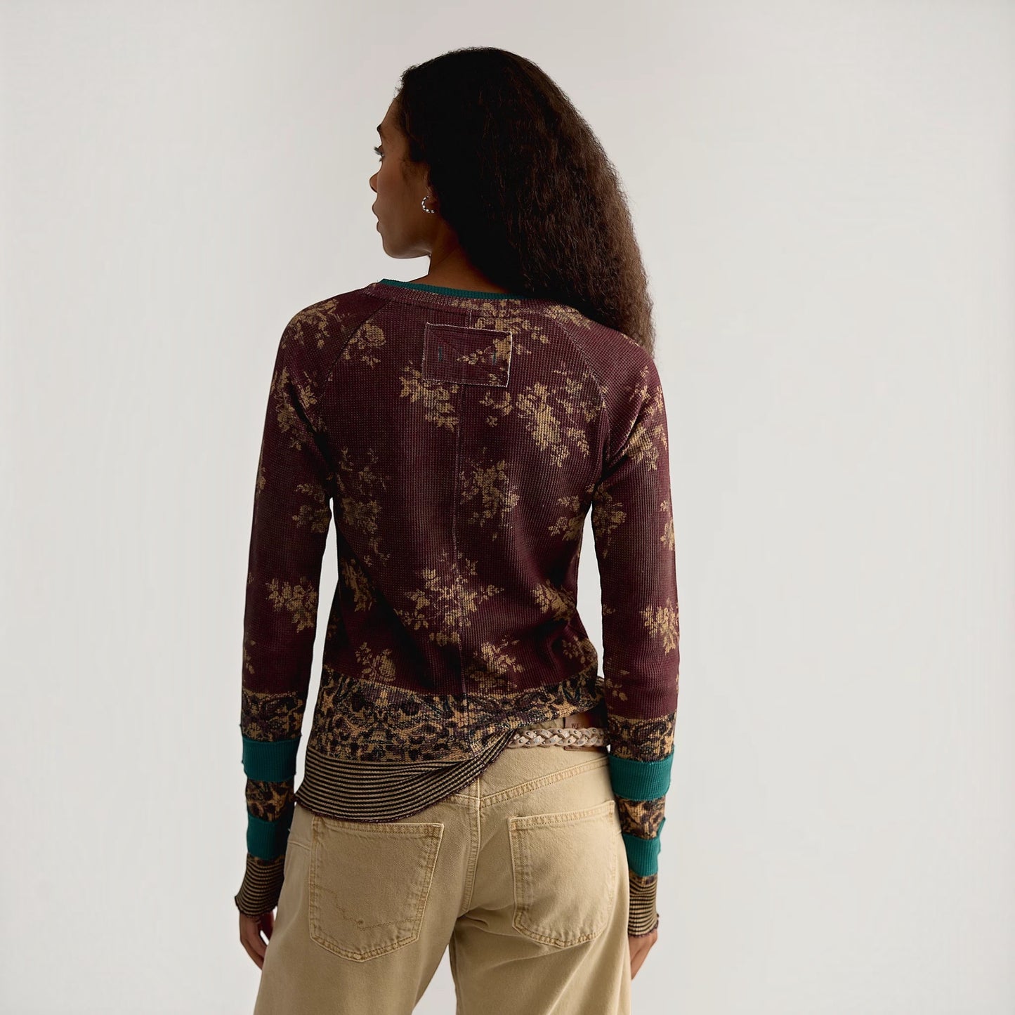 Plum Bottom Free People printed long sleeve ribbed top with crew neck and exaggerated cuffs worn by a model