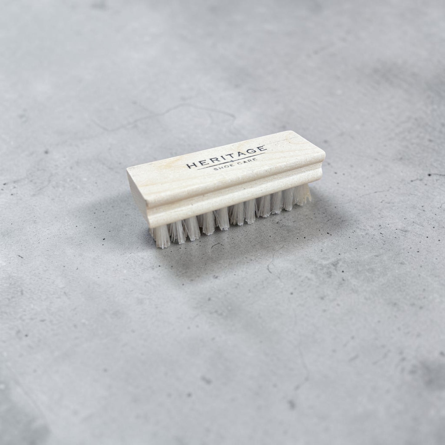 Plum Bottom Heritage Shoe Care suede brush with a light wood handle and soft white bristles