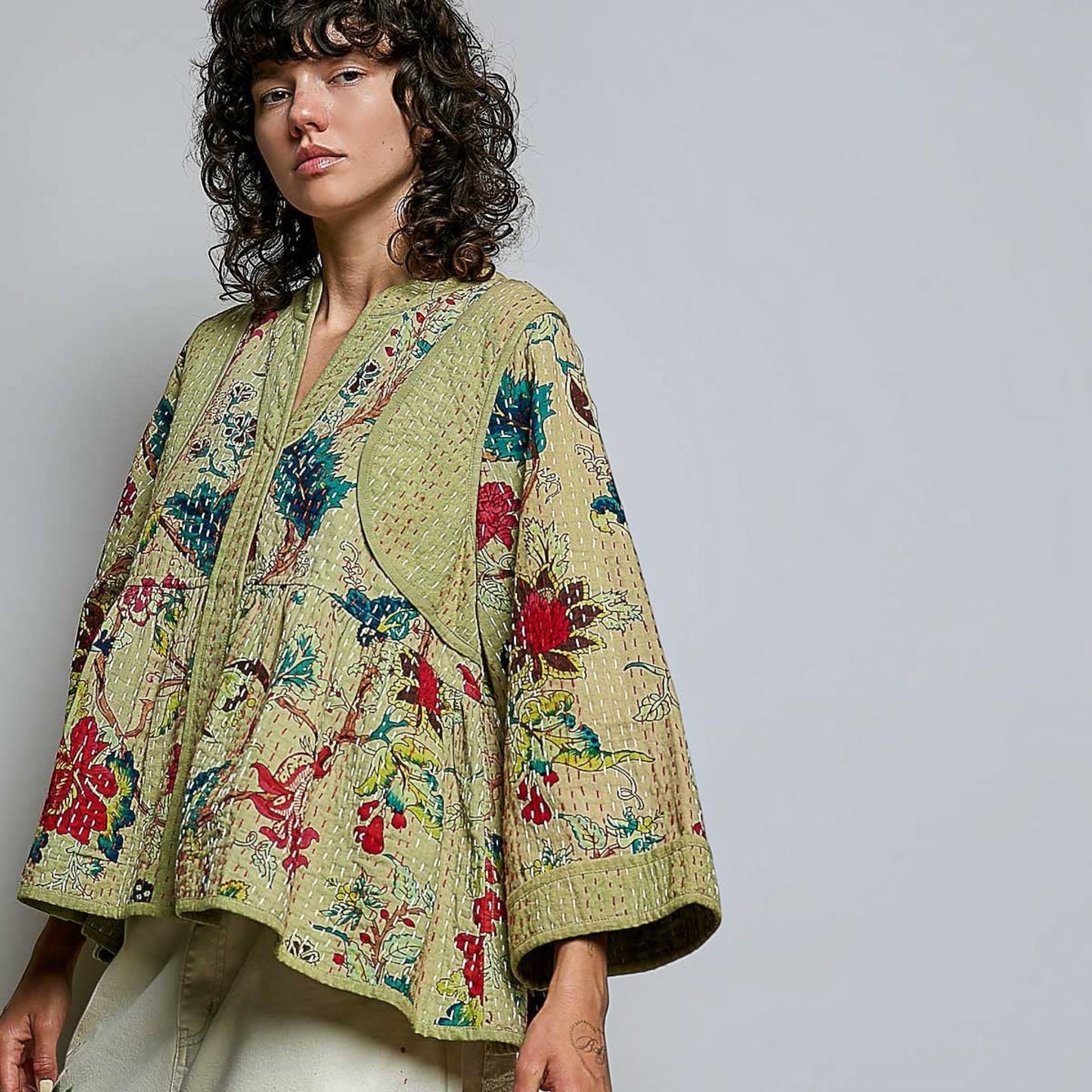 Plum Bottom Pol Clothing quilted floral kimono top in powder olive with hand-stitch detail and wide sleeves.