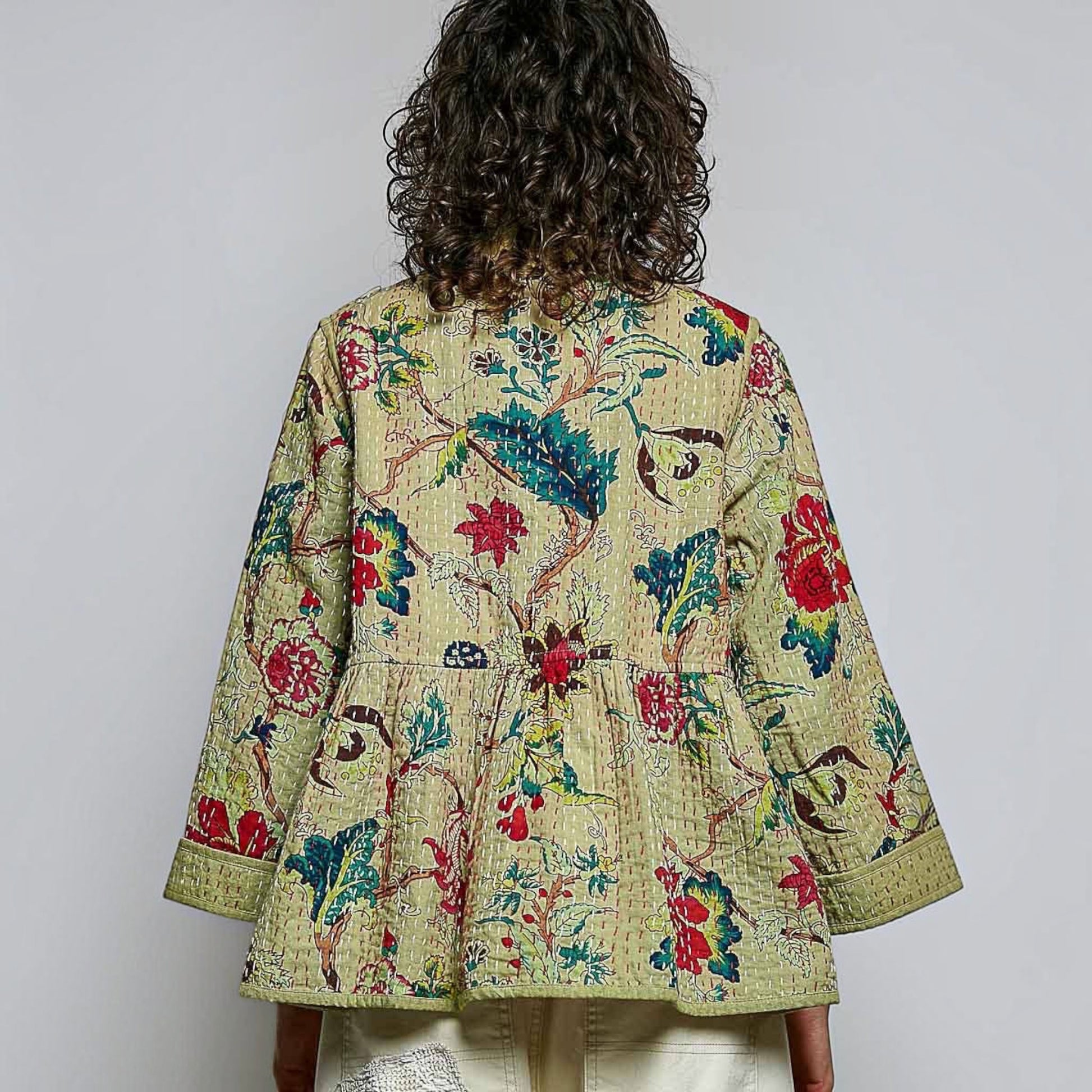 Plum Bottom quilted floral kimono-style top in powder olive with contrast hand-stitch detailing and wide sleeves.