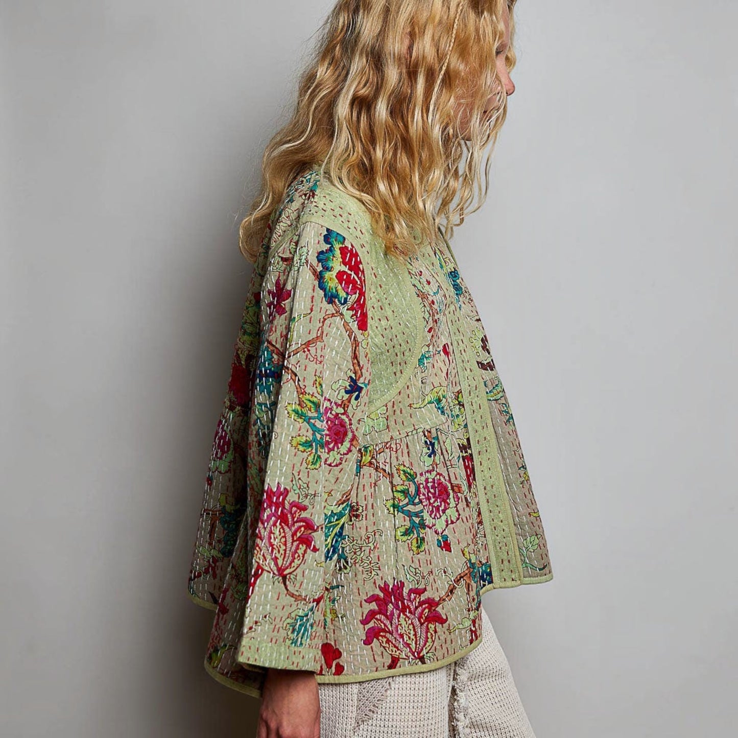 Plum Bottom quilted floral kimono-style top in powder olive with contrast hand-stitch detail and wide sleeves.