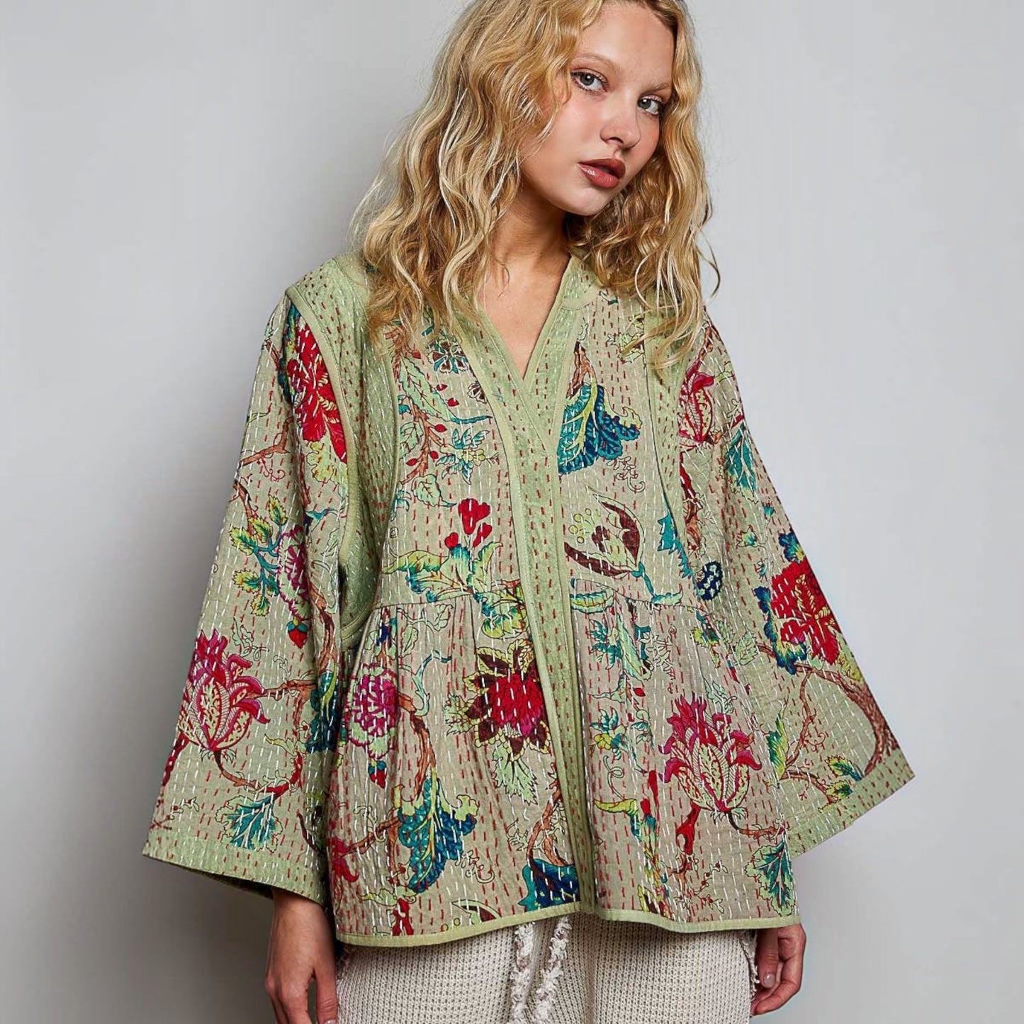 Plum Bottom quilted floral kimono-style top in powder olive with contrast hand-stitch detailing and wide sleeves.
