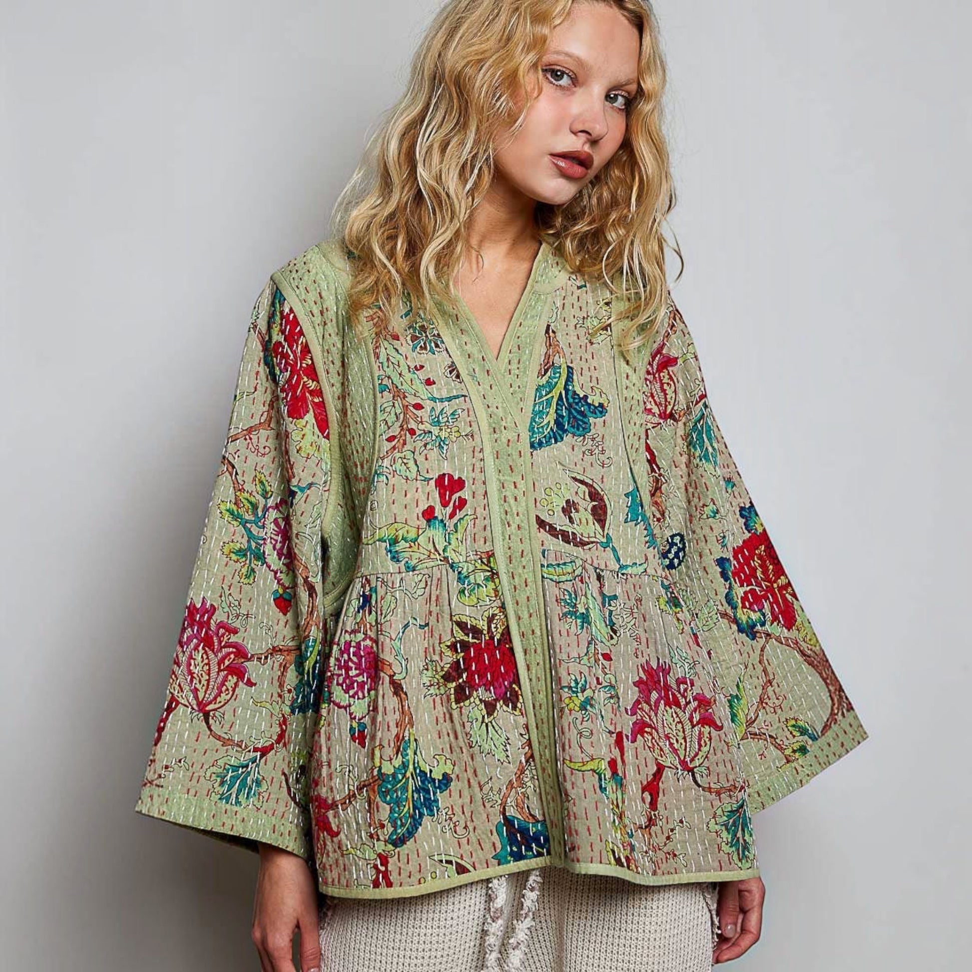 Plum Bottom quilted floral kimono-style top in powder olive with contrast hand-stitch detailing and wide sleeves.